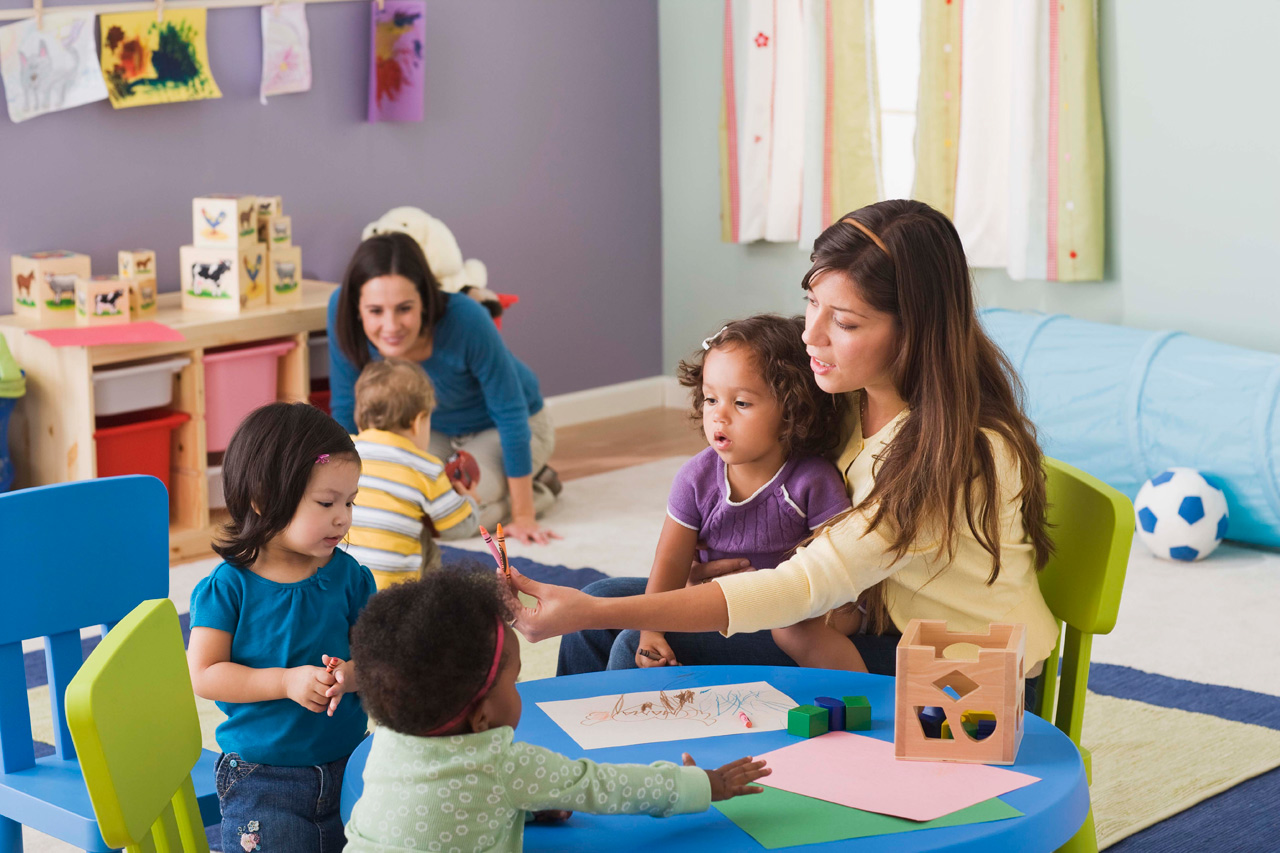 A teacher working with children in a preschool